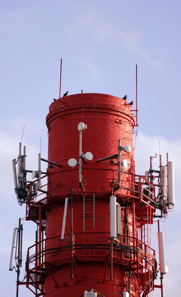 Punainen ja valkoinen putkikattila, jossa on kaapelit tietoliikennelaitteita, pääasiassa matkapuhelinsiirtoon
 - Valokuva, kuva