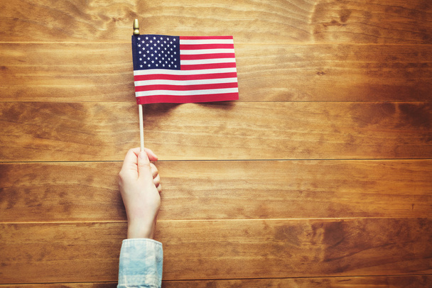 Person holding an American flag  - 写真・画像
