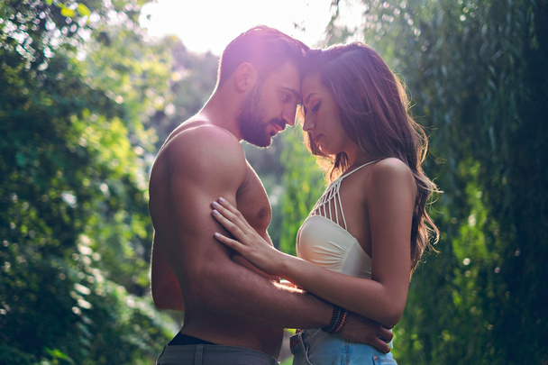 Couple holding each other in park sensually - Photo, Image