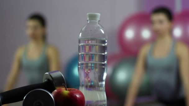 Young woman doing fitness exercises, keeping water balance, eating healthy food - Video
