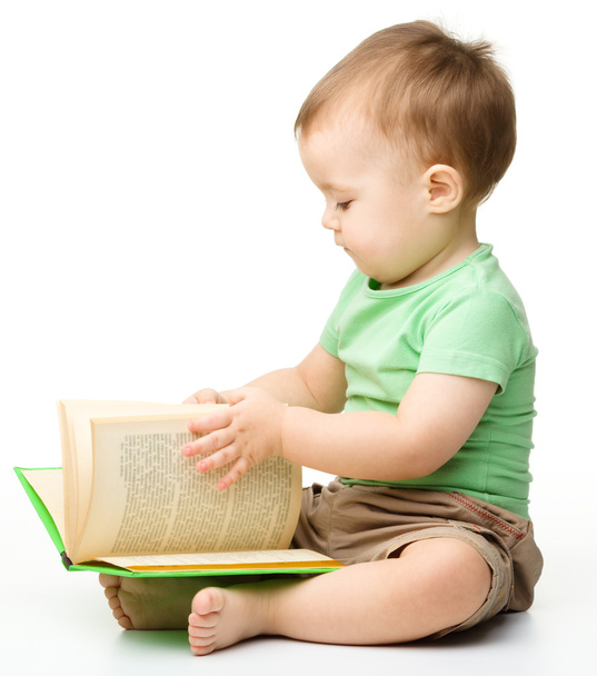 Cute little boy reads a book - Foto, Bild