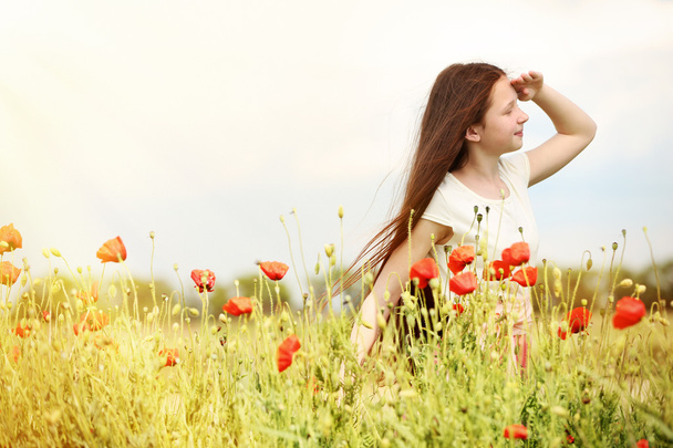 Beautiful girl in poppy field - Фото, изображение