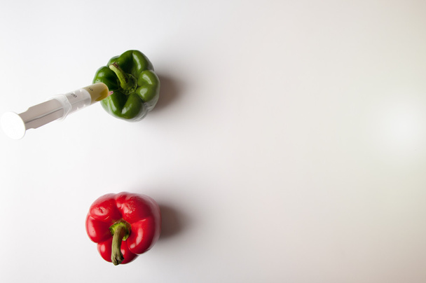 Green and reed pepper with syringe. GMO - Photo, Image