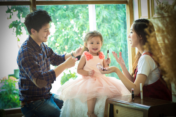 father,mother and daughter playing with makeup.  - Photo, Image