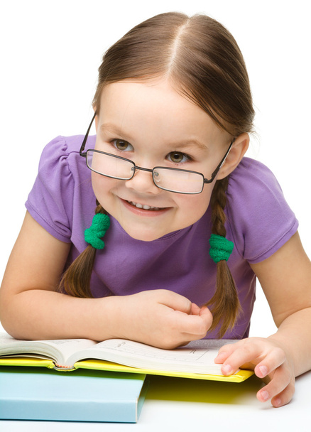 Cute cheerful little girl reading book - Zdjęcie, obraz