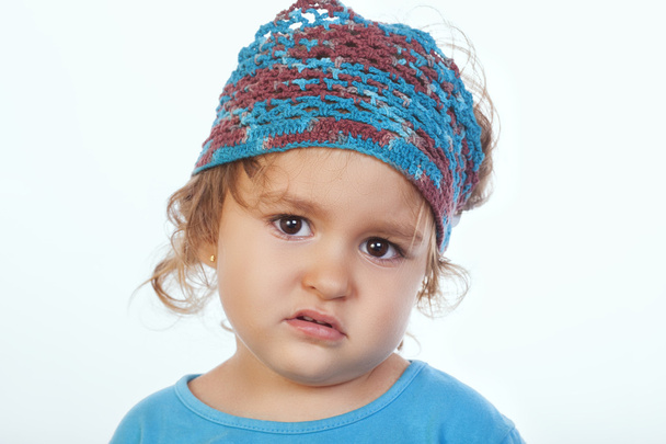 Bored little kid in handmade headband looking at camera - Foto, Imagen
