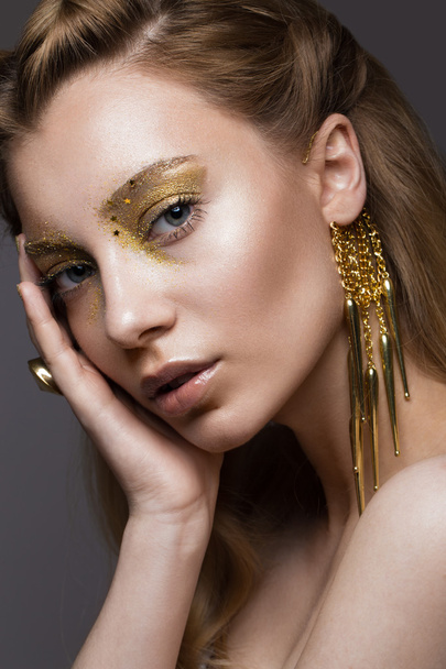 Beautiful girl in Underwear with creative gold makeup and hair. The beauty of the face. - Valokuva, kuva