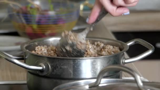 Arm Puts Buckwheat in a Bowl. - Footage, Video