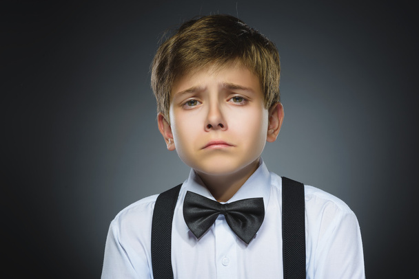 Portrait of offense crying boy isolated on gray background. Negative human emotion, facial expression. Closeup - Foto, immagini