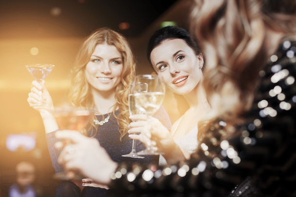 happy women with drinks at night club - 写真・画像