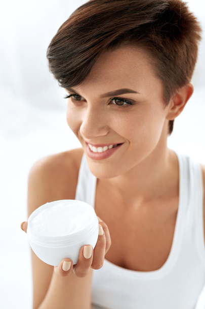 Skin Care. Beautiful Happy Woman Holding Face Cream, Lotion - Фото, изображение