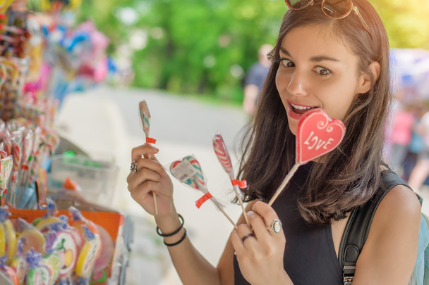 Smiling beautiful young woman with lollipops - Фото, зображення