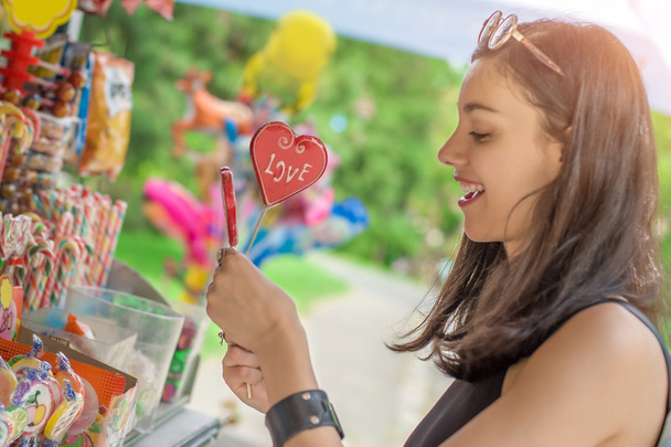 Smiling beautiful young woman with lollipops - 写真・画像