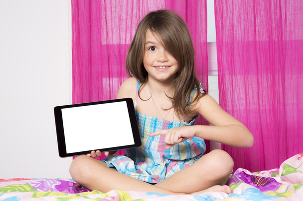 Technologies become easier. Cute little girl holding digital tablet - 写真・画像