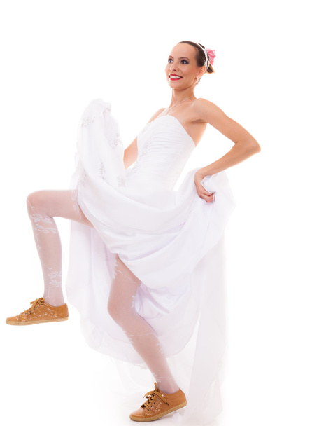 Wedding. Running bride funny woman in sport shoes - Photo, image