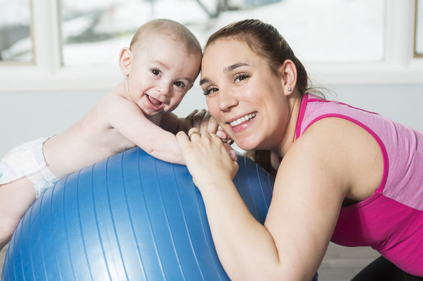 Mother with child boy doing fitness exercises - Foto, Imagen