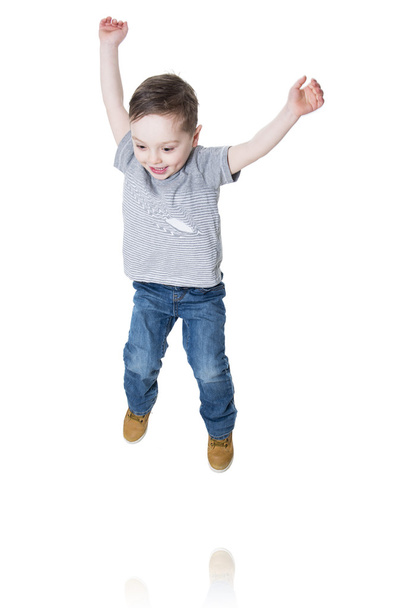 Little boy jumping in the air - 写真・画像