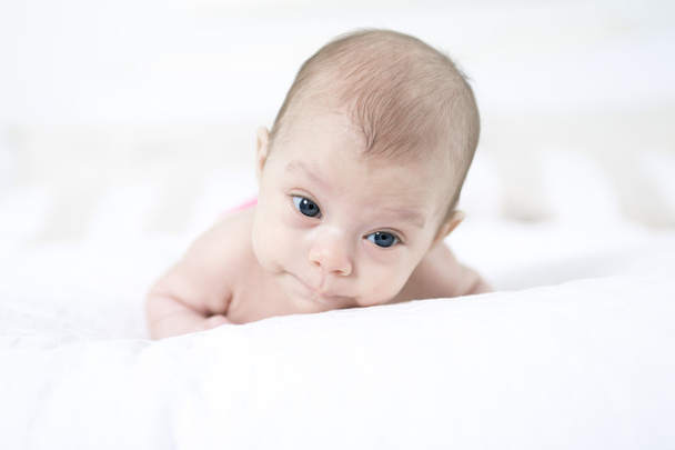 cute two-month-old girl lying in bed - Foto, Imagem