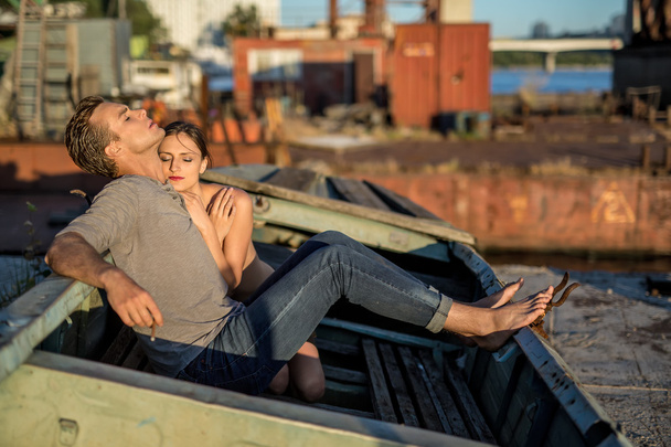 Sexy couple in old boat - Photo, image