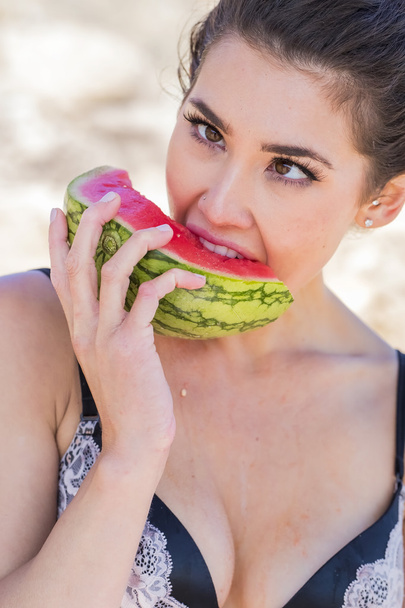 Woman eating watermelon on each - Photo, Image