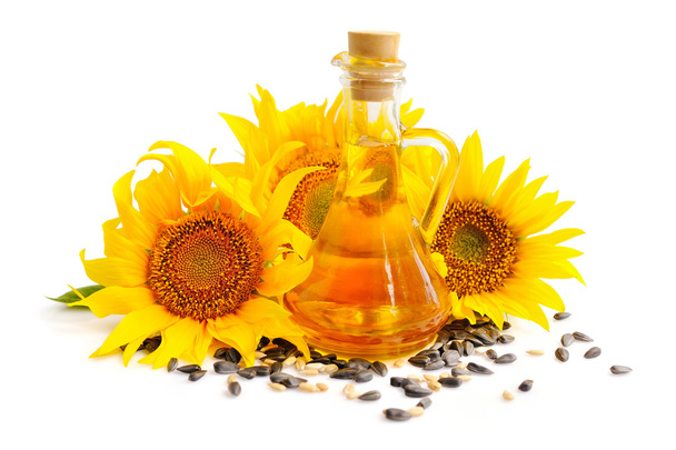 Sunflower oil with flowers and by seed on white background - Photo, Image