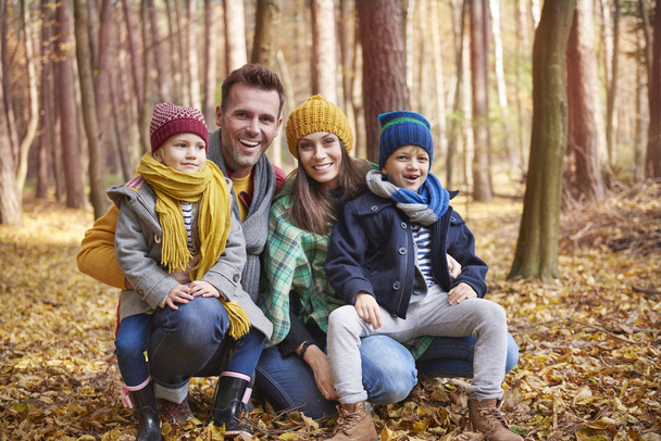 Family enjoying autumn in the forest  - Foto, afbeelding