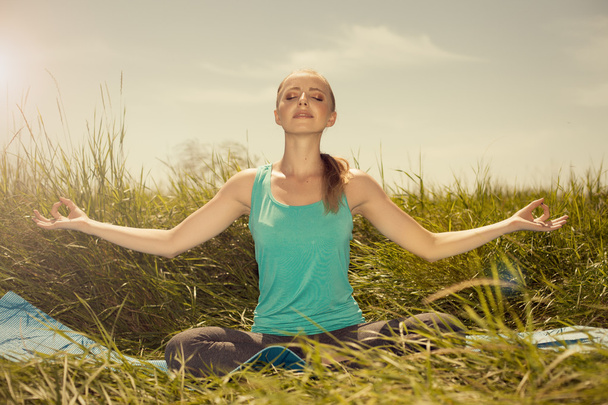 Красота подходит блондинка молодая женщина медитирует на природе с глазами
  - Фото, изображение