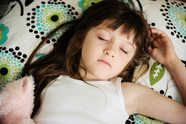 Portrait of sleeping little girl in bed - Фото, изображение
