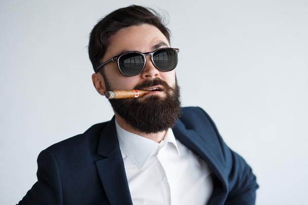 male with moustache and beard smoking cigar - 写真・画像