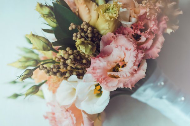 Beautiful autumn, bridal bouquet of wedding flowers roses, eustoma, Berries with white tape. Pastel colors orange, peach pink, yellow. Rustic style, still life. Holiday  floristic. Fall gold Marriage - Foto, immagini