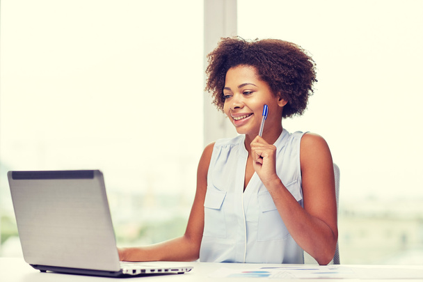 happy african woman with laptop at office - Photo, image