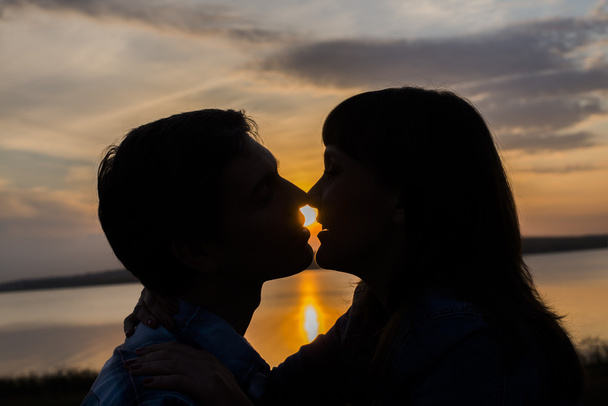 Silhouette of kissing romantic couple in love - Photo, Image