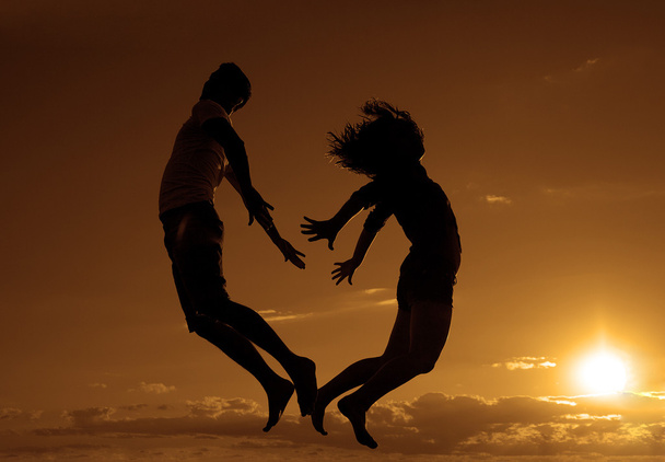 man and woman jumping on the beach - Foto, Bild