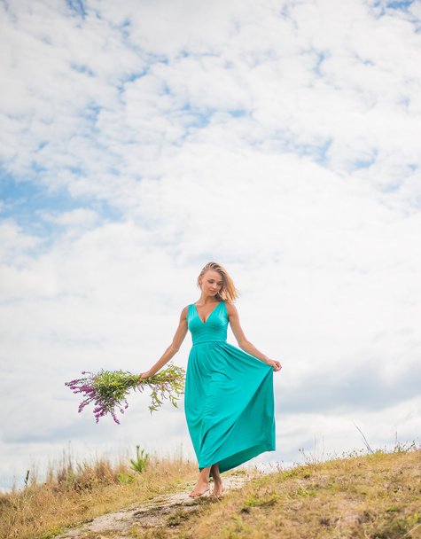 girl with wild spring flowers.  - Photo, Image