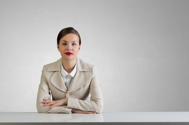 Businesswoman sitting at desk . Mixed media - Fotoğraf, Görsel