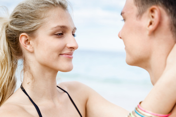 Romantic young couple standing on the beach - Photo, Image