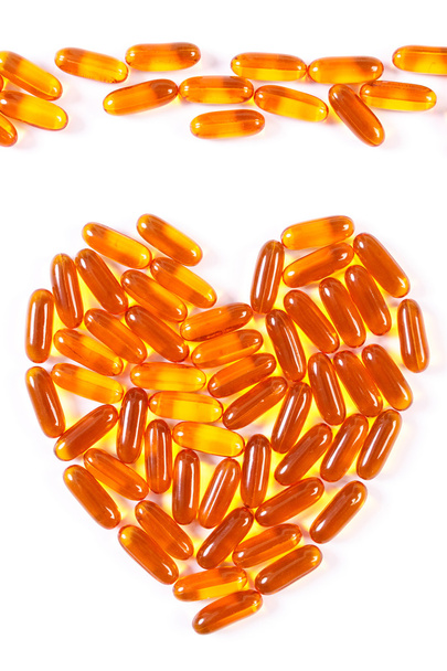 Heart shaped medical pills and capsules on white background, health care concept - Zdjęcie, obraz