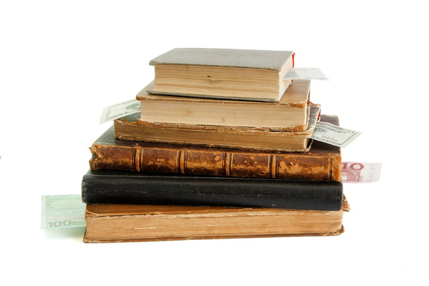 Stack of old books with money bookmarks - Photo, Image
