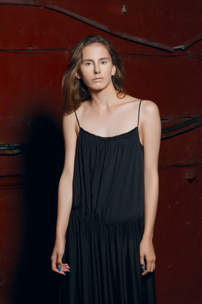 fashion model in long designers black dress in night show - Fotó, kép