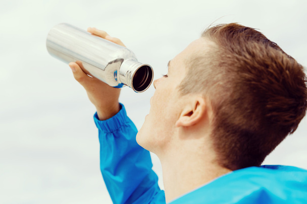 Man drinking from a sports bottle - Zdjęcie, obraz
