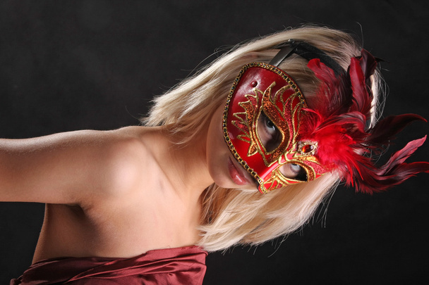blonde in mask with a beautiful neck on black background - Фото, зображення