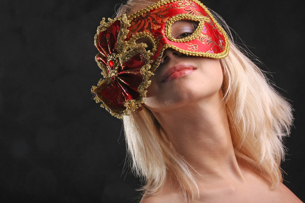 emotions on the face of the girl in the Venetian mask on black background - Fotó, kép
