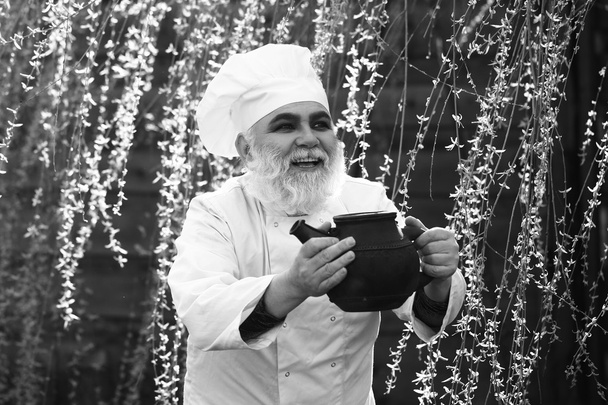bearded cook with iron tea kettle - Foto, imagen