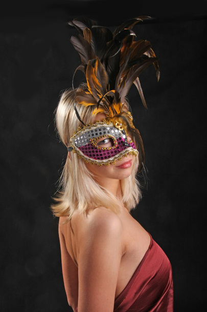 emoties op het gezicht van het meisje in het Venetiaanse masker op zwarte achtergrond - Foto, afbeelding