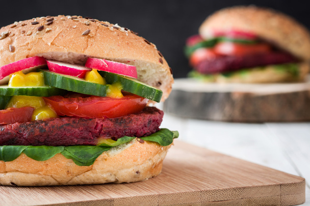 Veggie beet burger on white table and black slate background - Zdjęcie, obraz