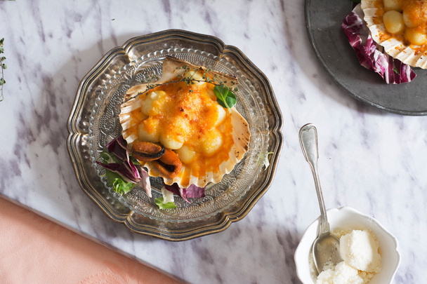 Pasta de ñoquis con mejillones, tomate y sala de crema
 - Foto, imagen