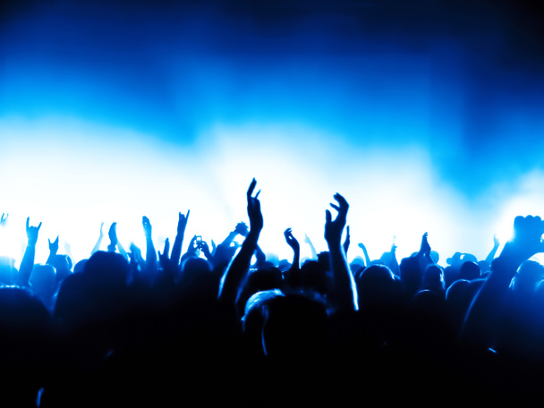 silhouettes of concert crowd in front of bright stage lights - Fotoğraf, Görsel