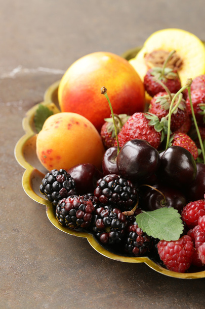 various fresh organic berries on a vintage silver plate - 写真・画像