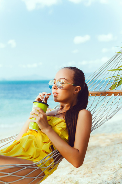  beautiful  woman with cocktail   on the beach - 写真・画像