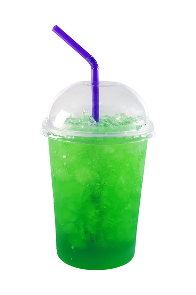 Green soda and ice in plastic glass isolated on white background - Photo, Image